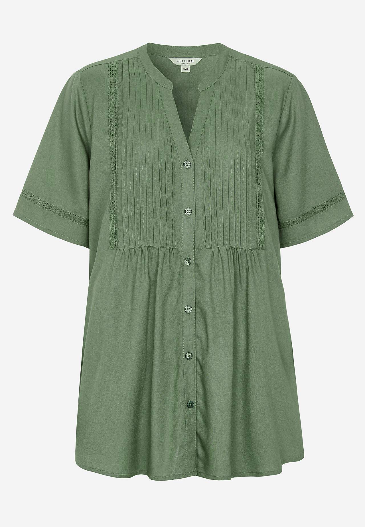 Kudottu tunika pitsireunuksilla